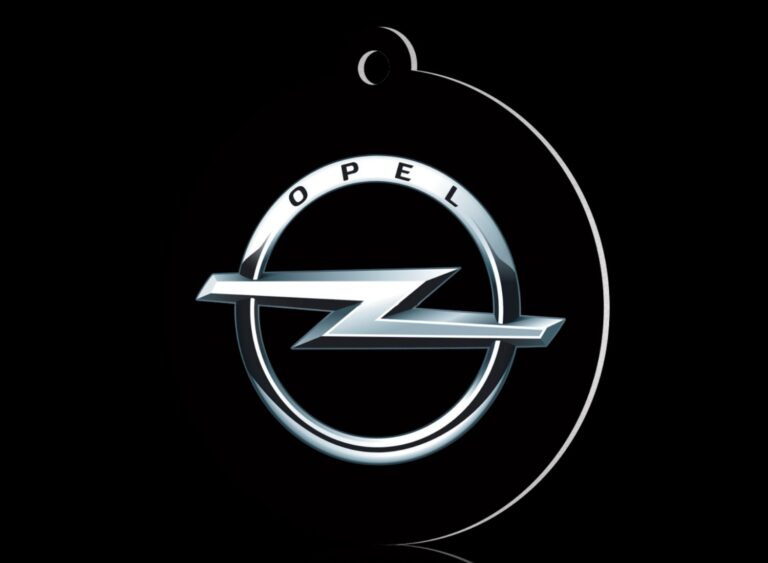 Oryginalna zawieszka zapachowa - zapach samochodowy z wyeksponowanym srebrnym logo marki Opel na czarnym tle.